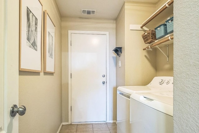 606 Indian Run Dr, Pflugerville, TX 78660 - laundry area with washer and clothes dryer and light tile patterned floors