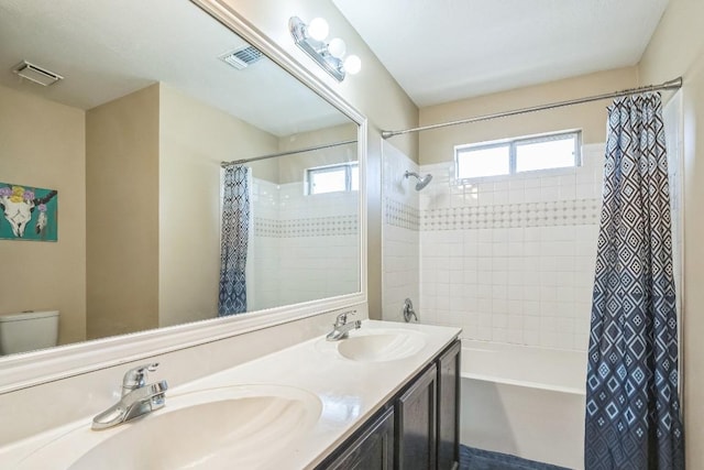 606 Indian Run Dr, Pflugerville, TX 78660 - full bath with shower / tub combo, toilet, healthy amount of natural light, and double vanity