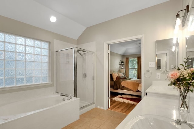 606 Indian Run Dr, Pflugerville, TX 78660 - ensuite bathroom featuring a garden tub, a stall shower, double vanity, tile patterned flooring, and lofted ceiling
