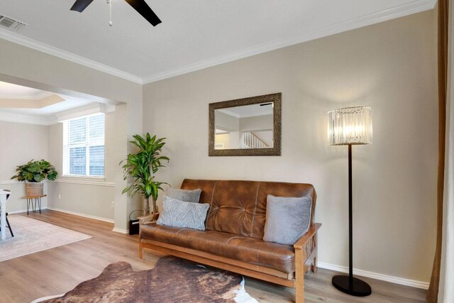 606 Indian Run Dr, Pflugerville, TX 78660 - living area with wood finished floors, crown molding, and a ceiling fan