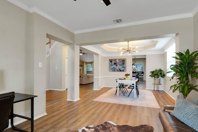 606 Indian Run Dr, Pflugerville, TX 78660 - dining area featuring ceiling fan, light wood-style flooring, crown molding, a chandelier, and baseboards
