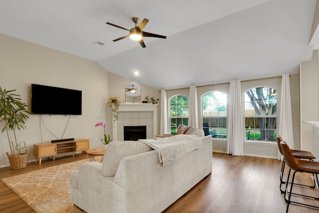 606 Indian Run Dr, Pflugerville, TX 78660 - living area with ceiling fan, a fireplace, wood finished floors, and vaulted ceiling