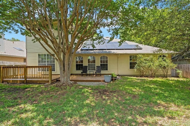 606 Indian Run Dr, Pflugerville, TX 78660 - rear view of property featuring roof mounted solar panels and a wooden deck