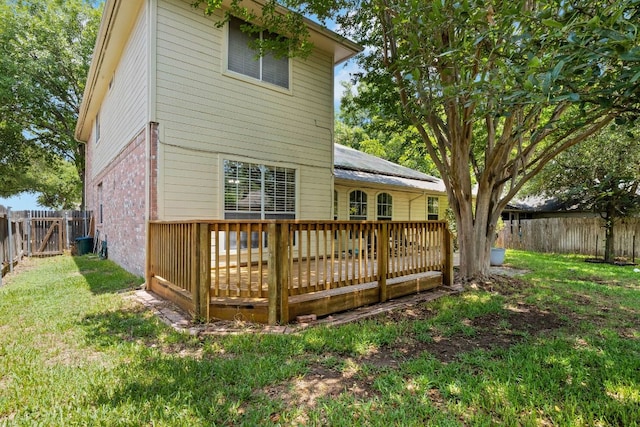 606 Indian Run Dr, Pflugerville, TX 78660 - rear view of property featuring brick siding, a deck, and a fenced backyard