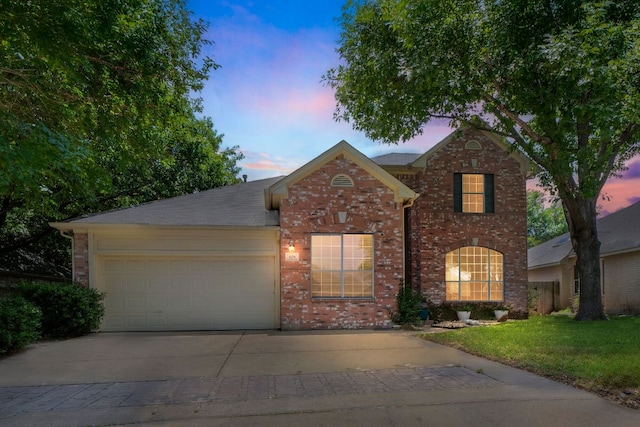 606 Indian Run Dr, Pflugerville, TX 78660 - traditional home featuring brick siding, an attached garage, and driveway
