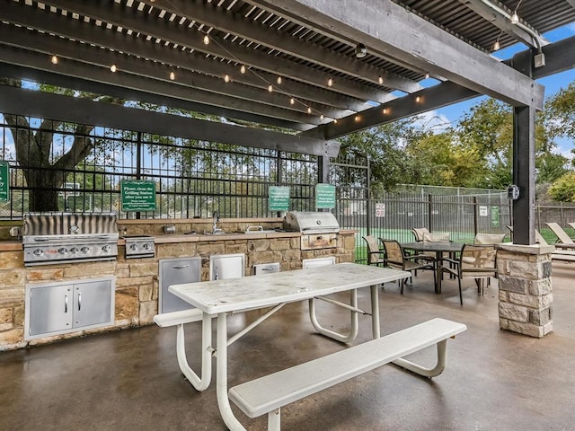 606 Indian Run Dr, Pflugerville, TX 78660 - view of patio / terrace featuring outdoor dining space, exterior kitchen, and a pergola
