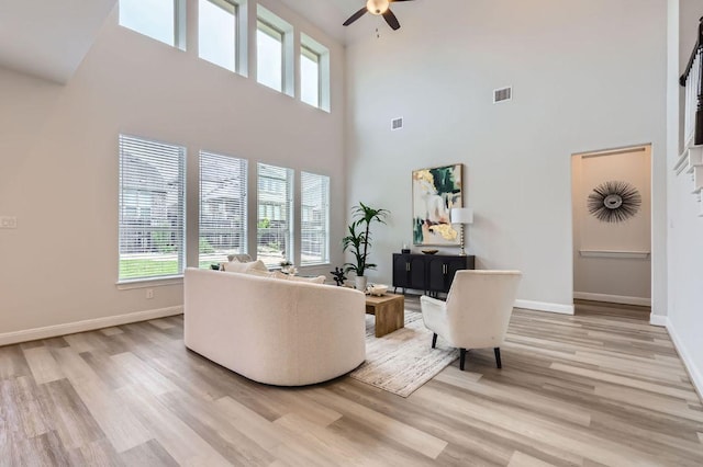 508 Landing Ln, Leander, TX 78641 - living area with ceiling fan, a high ceiling, and light wood-style flooring