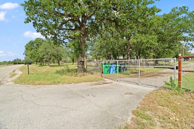 3434 Prairie Lea Rd, Kingsbury, TX 78638 - view of asphalt road featuring a gate