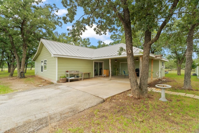 3434 Prairie Lea Rd, Kingsbury, TX 78638 - view of front of home featuring driveway, an attached carport, a metal roof, a patio, and ceiling fan
