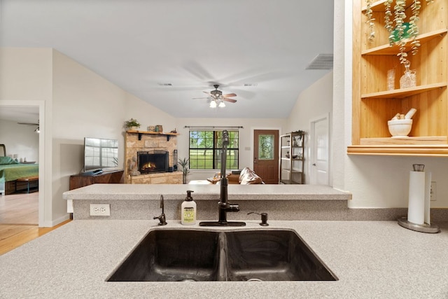 3434 Prairie Lea Rd, Kingsbury, TX 78638 - kitchen with a ceiling fan, vaulted ceiling, a fireplace, open floor plan, and light countertops