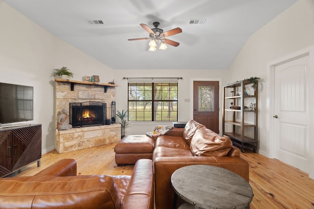 3434 Prairie Lea Rd, Kingsbury, TX 78638 - living room with vaulted ceiling, a stone fireplace, ceiling fan, and wood finished floors