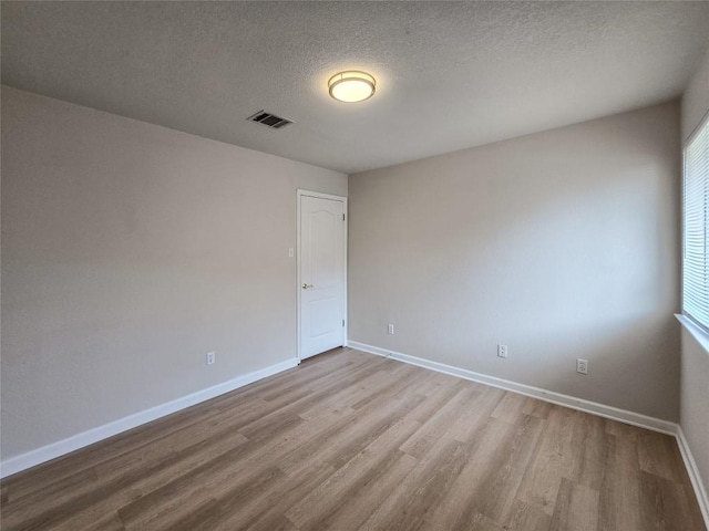 9403 Tea Rose Trl, Austin, TX 78748 - empty room with wood finished floors, baseboards, and a textured ceiling