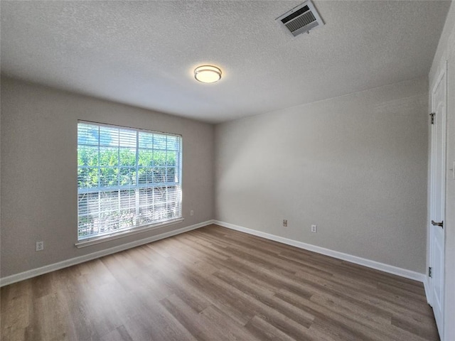 9403 Tea Rose Trl, Austin, TX 78748 - empty room featuring dark wood-type flooring, baseboards, and a textured ceiling