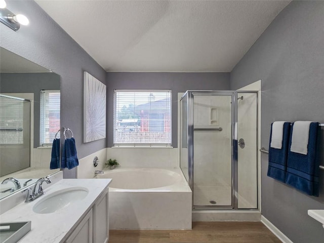 9403 Tea Rose Trl, Austin, TX 78748 - bathroom featuring plenty of natural light, wood finished floors, a bath, a stall shower, and a textured ceiling