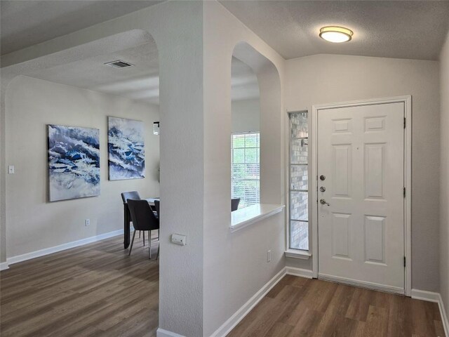 9403 Tea Rose Trl, Austin, TX 78748 - entrance foyer with dark wood-style floors, arched walkways, vaulted ceiling, and baseboards