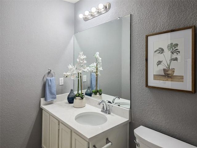 9403 Tea Rose Trl, Austin, TX 78748 - bathroom featuring vanity, toilet, and a textured wall