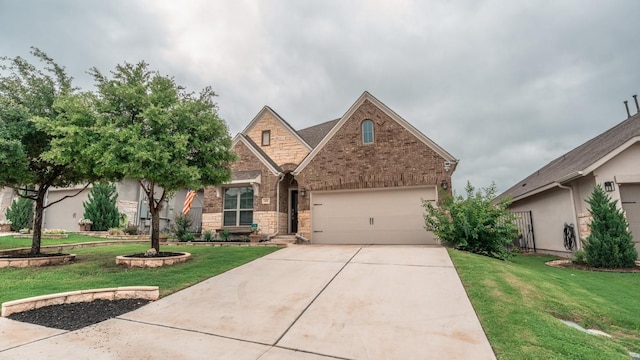 108 Berkeley Pl, Georgetown, TX 78628 - view of front facade featuring concrete driveway, a garage, a front yard, and stone siding