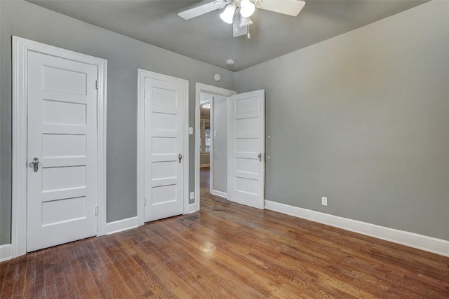 1309 E 13th St, Austin, TX 78702 - unfurnished bedroom featuring baseboards, wood finished floors, and ceiling fan