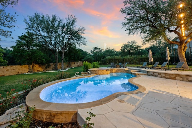 7609 Lazy River Cv, Austin, TX 78730 - pool at dusk with a patio, a lawn, and a pool with connected hot tub