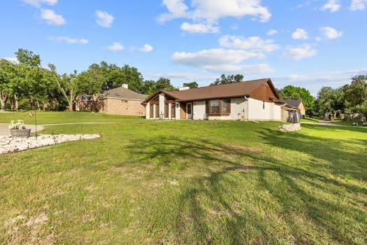 2305 Canyon Creek Dr, Temple, TX 76502 - rear view of property with a lawn