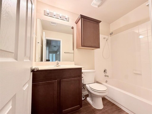 110 Carbine Ct, Bastrop, TX 78602 - full bathroom with toilet, vanity, washtub / shower combination, and wood finished floors