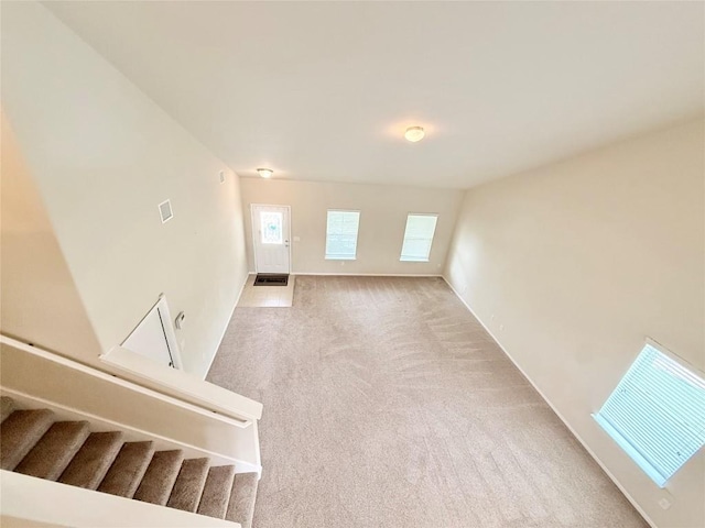 110 Carbine Ct, Bastrop, TX 78602 - unfurnished living room with carpet flooring and stairs