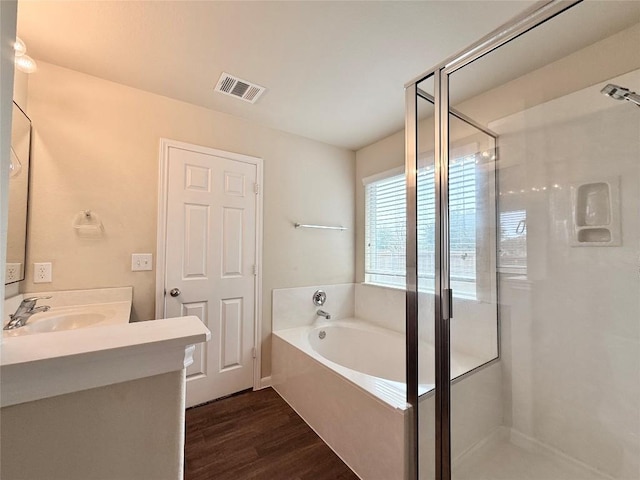 110 Carbine Ct, Bastrop, TX 78602 - bathroom featuring a shower stall, a bath, vanity, and wood finished floors