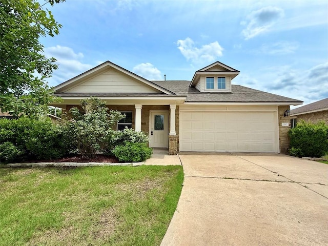 110 Carbine Ct, Bastrop, TX 78602 - view of front of home featuring a garage, concrete driveway, roof with shingles, a front yard, and stone siding