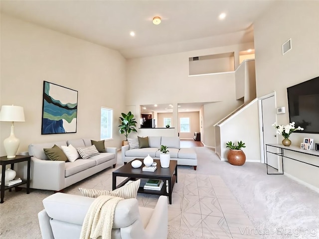 110 Carbine Ct, Bastrop, TX 78602 - living room with light colored carpet, a towering ceiling, recessed lighting, and baseboards