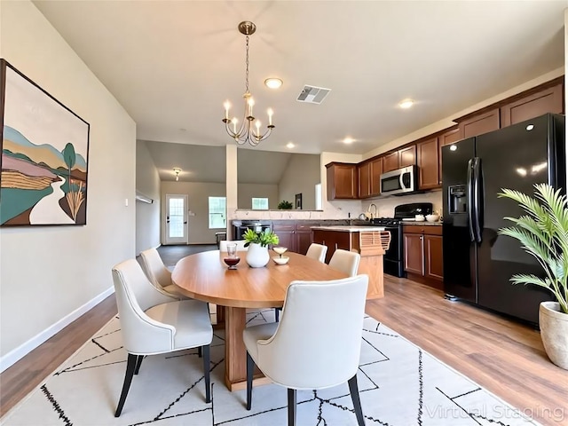 110 Carbine Ct, Bastrop, TX 78602 - dining room featuring a chandelier, light wood finished floors, baseboards, and recessed lighting