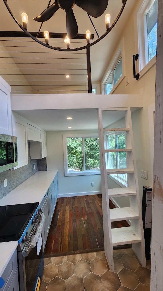 1134 Lott Ave, Austin, TX 78721 - kitchen with stainless steel microwave, electric range oven, light countertops, a chandelier, and white cabinets