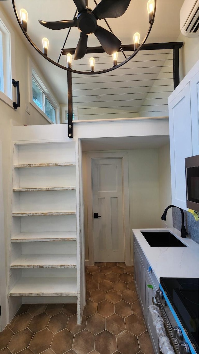 1134 Lott Ave, Austin, TX 78721 - washroom with a sink, a wall mounted AC, dark tile patterned flooring, and ceiling fan