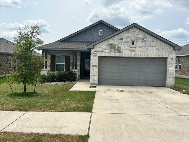520 Warlander Way, Georgetown, TX 78626 - view of front of home with stone siding, driveway, a front lawn, and a garage