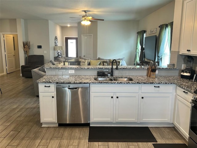 520 Warlander Way, Georgetown, TX 78626 - kitchen featuring dishwasher, open floor plan, a sink, ceiling fan, and dark stone counters