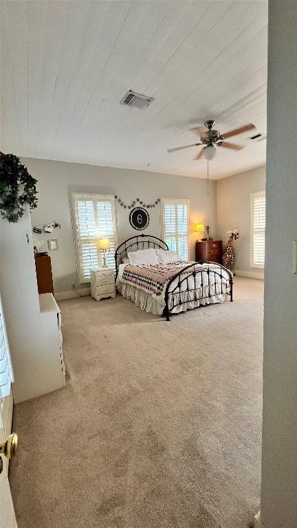 636 Franklin St S, La Grange, TX 78945 - carpeted bedroom featuring multiple windows, ceiling fan, and wooden ceiling