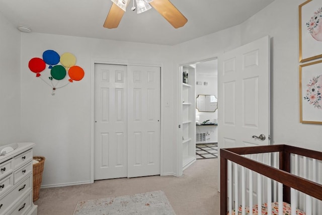 8804 Peppergrass Cv, Austin, TX 78745 - bedroom featuring light colored carpet, a closet, a ceiling fan, a crib, and baseboards