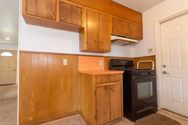 6903 N La Salle Dr, Austin, TX 78723 - kitchen featuring gas stove, under cabinet range hood, a wainscoted wall, brown cabinets, and light countertops