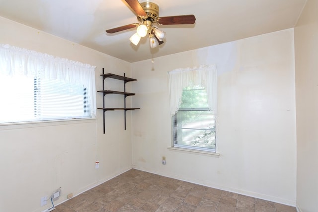 6903 N La Salle Dr, Austin, TX 78723 - unfurnished room featuring plenty of natural light, ceiling fan, and baseboards