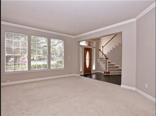 15022 Galena Dr, Austin, TX 78717 - entrance foyer featuring carpet flooring, crown molding, baseboards, and stairs