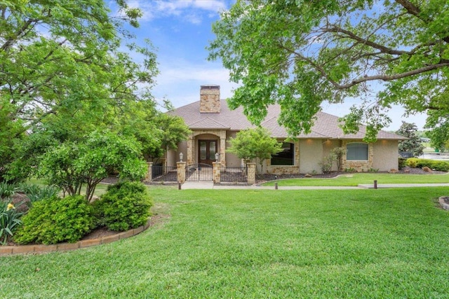 1111 Mill Creek Dr, Salado, TX 76571 - view of front of home featuring stone siding, french doors, a front yard, and a chimney