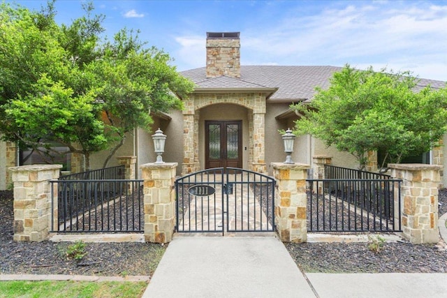 1111 Mill Creek Dr, Salado, TX 76571 - view of front of house featuring french doors, a fenced front yard, a gate, and stone siding