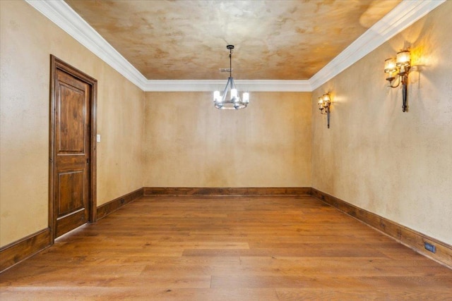 1111 Mill Creek Dr, Salado, TX 76571 - empty room with wood finished floors, a chandelier, and crown molding