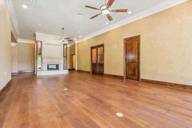 1111 Mill Creek Dr, Salado, TX 76571 - unfurnished living room with ceiling fan, crown molding, wood finished floors, a fireplace, and recessed lighting