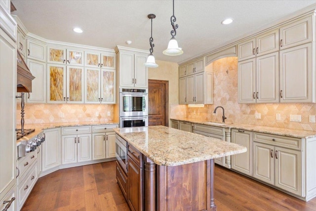 1111 Mill Creek Dr, Salado, TX 76571 - kitchen with appliances with stainless steel finishes, dark wood finished floors, decorative backsplash, pendant lighting, and recessed lighting