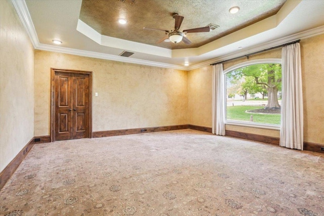 1111 Mill Creek Dr, Salado, TX 76571 - carpeted empty room featuring a tray ceiling, ceiling fan, and crown molding