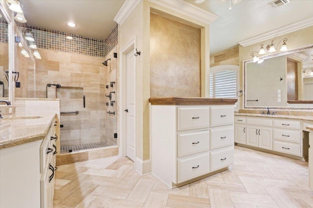 1111 Mill Creek Dr, Salado, TX 76571 - bathroom with a shower stall, two vanities, and crown molding