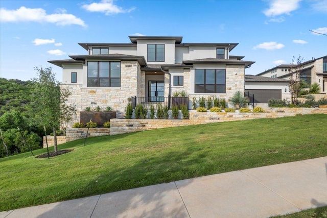 3008 Soldato Way, Leander, TX 78641 - view of front facade with stone siding, a front lawn, and an attached garage