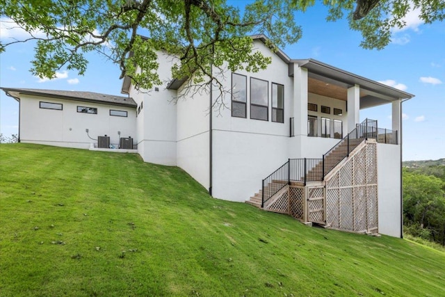 3008 Soldato Way, Leander, TX 78641 - rear view of house featuring stairway, stucco siding, and a lawn