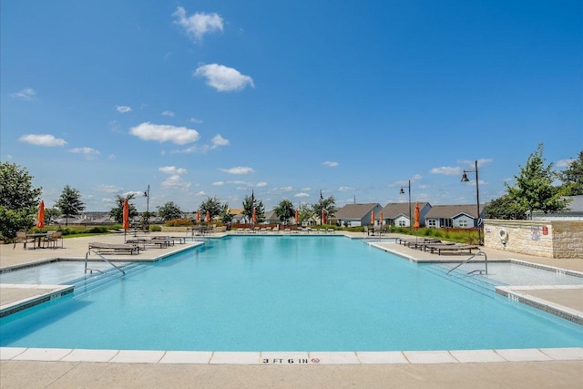 101 Wind Flower Ln, Liberty Hill, TX 78642 - community pool featuring a patio