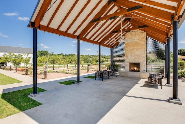 101 Wind Flower Ln, Liberty Hill, TX 78642 - view of patio / terrace featuring an outdoor stone fireplace and a ceiling fan